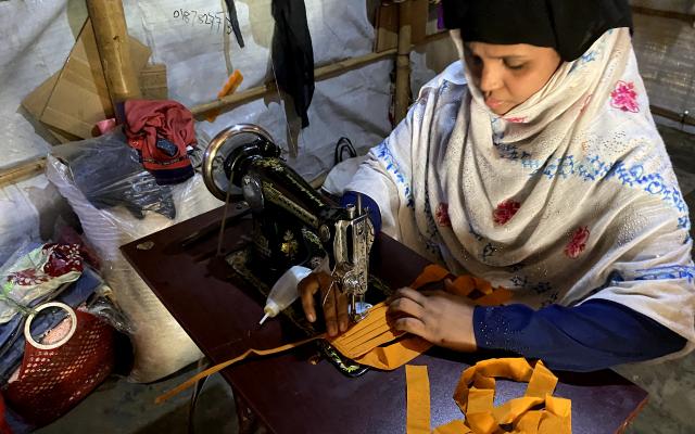 A Women’s Group member in Kutupalong Camp makes a cloth facemask.